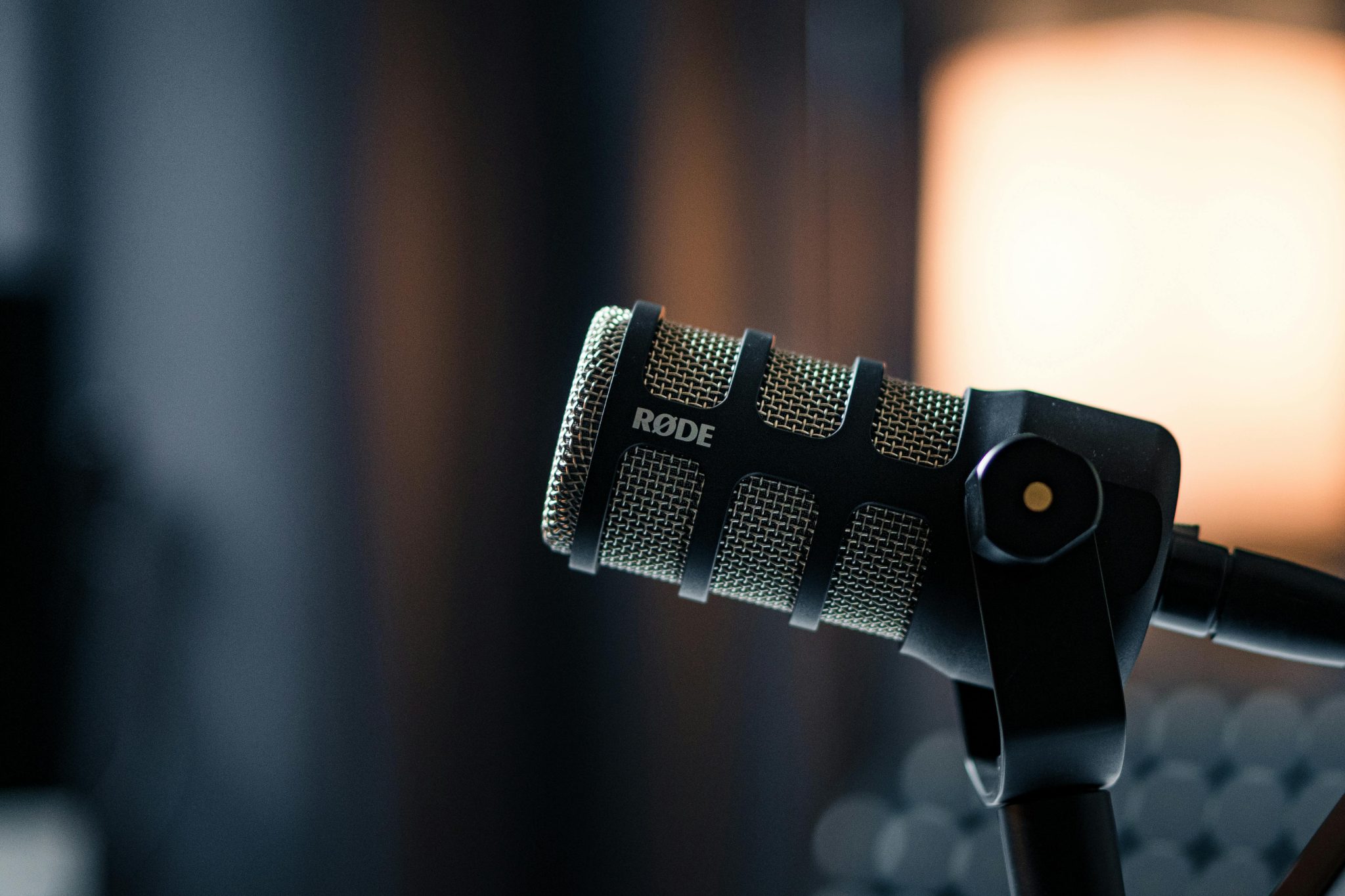 Close-up of a Rode microphone in a studio, emphasizing professional audio equipment.